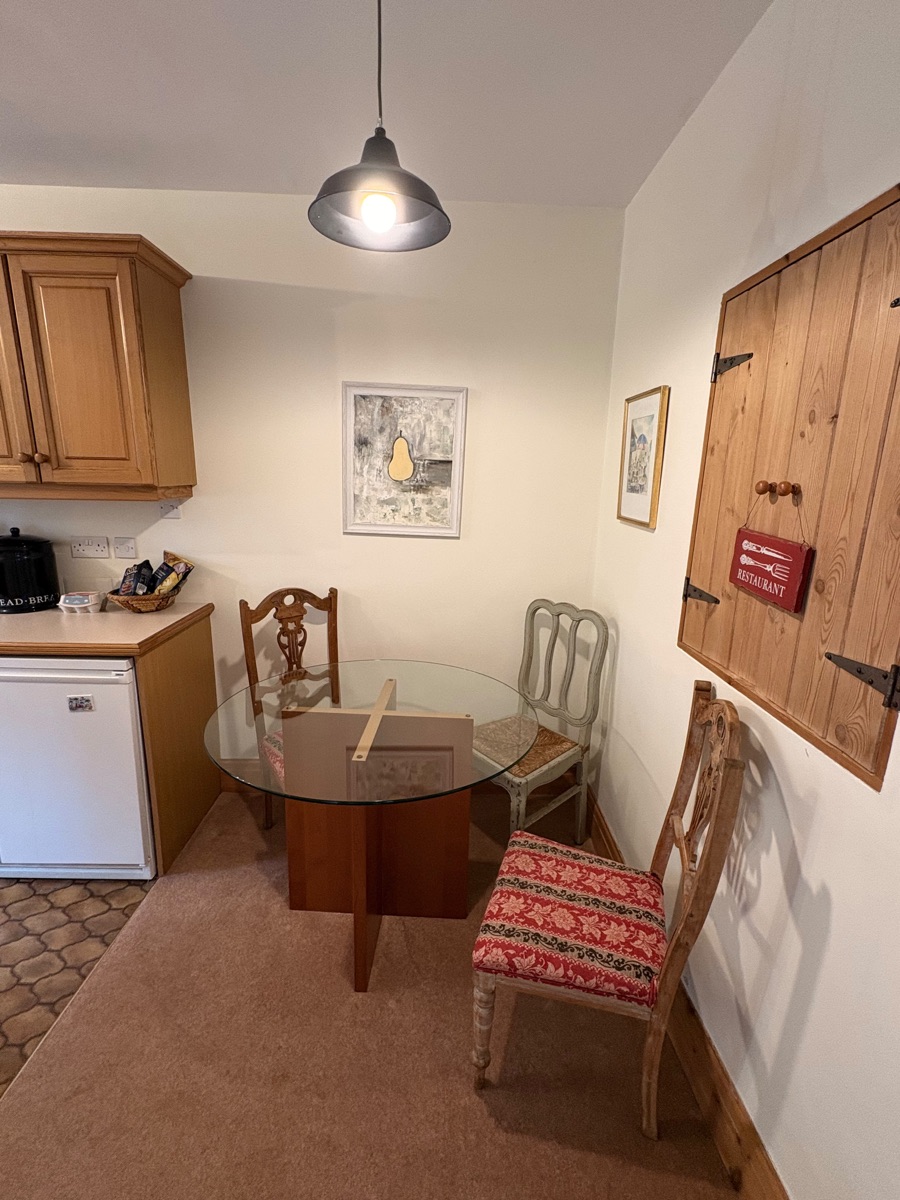 Round dining table and characterful mix of chairs