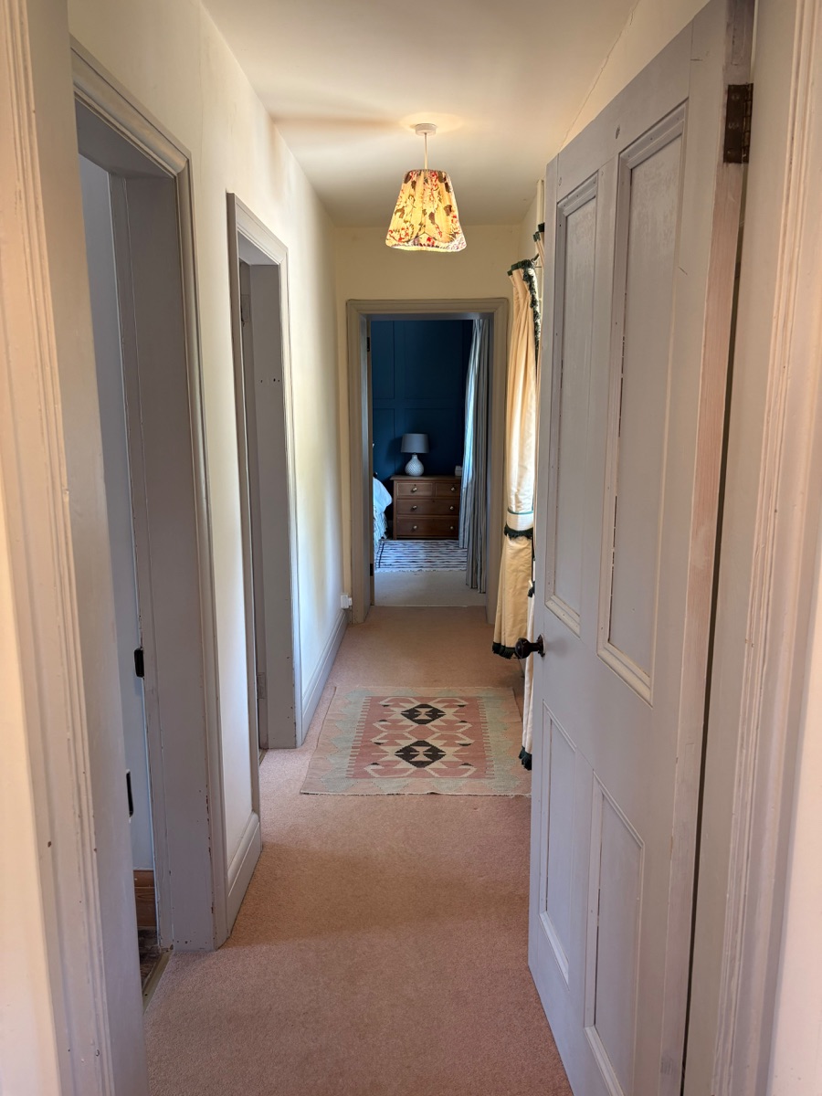 Bright single-level hallway connecting the cottage rooms