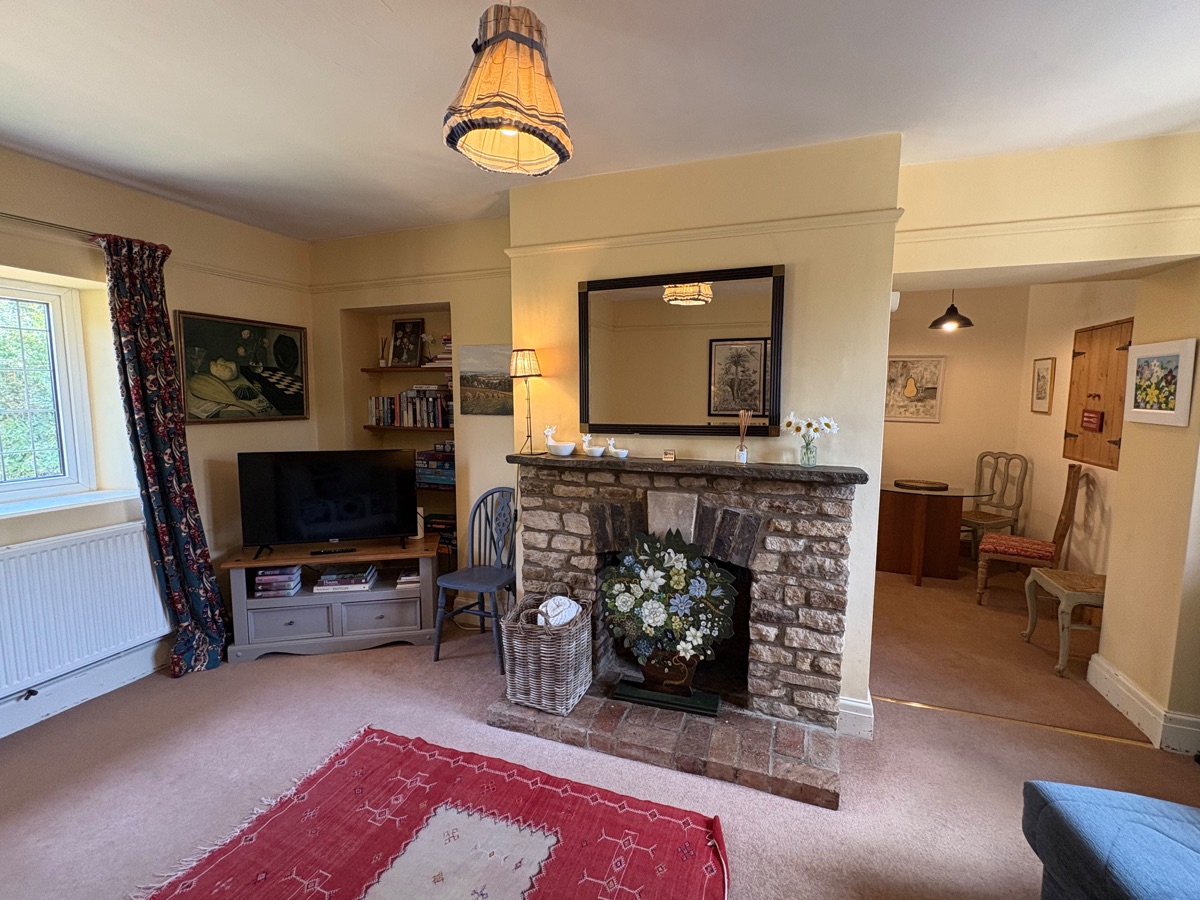 Cosy living room centred around the stone fireplace